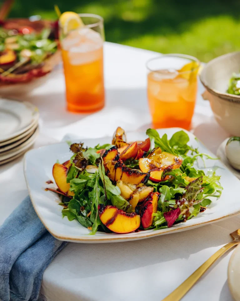 Served grilled peach salad with dressing