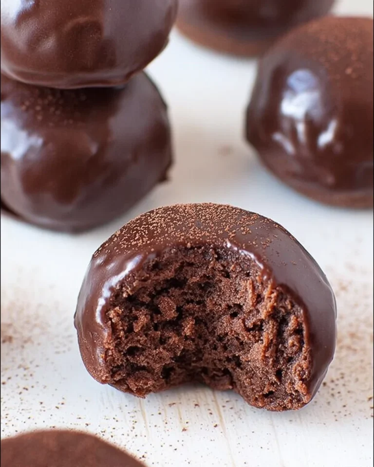 Keto chocolate donuts plated and drizzled with sugar-free chocolate