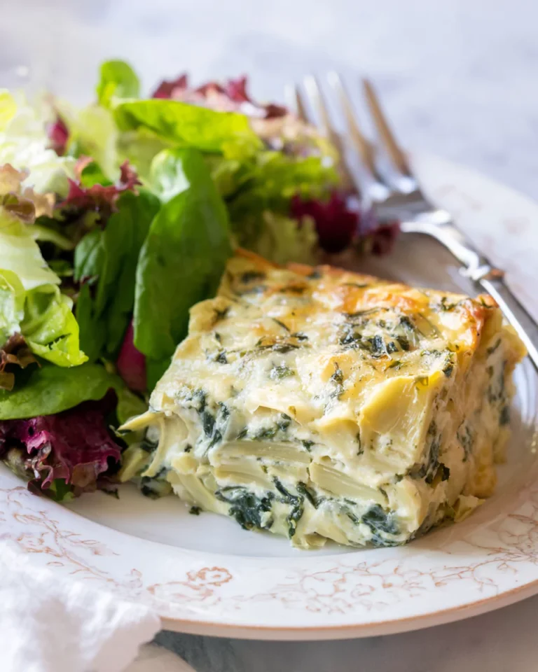 Slice of spinach artichoke bake served on plate