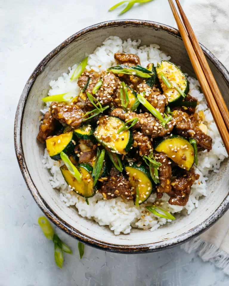 Bowl of zucchini beef stir-fry over jasmine rice