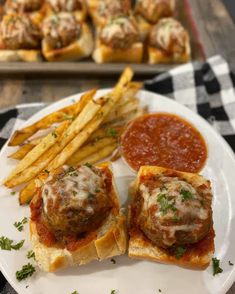 Meatball sliders served with marinara sauce
