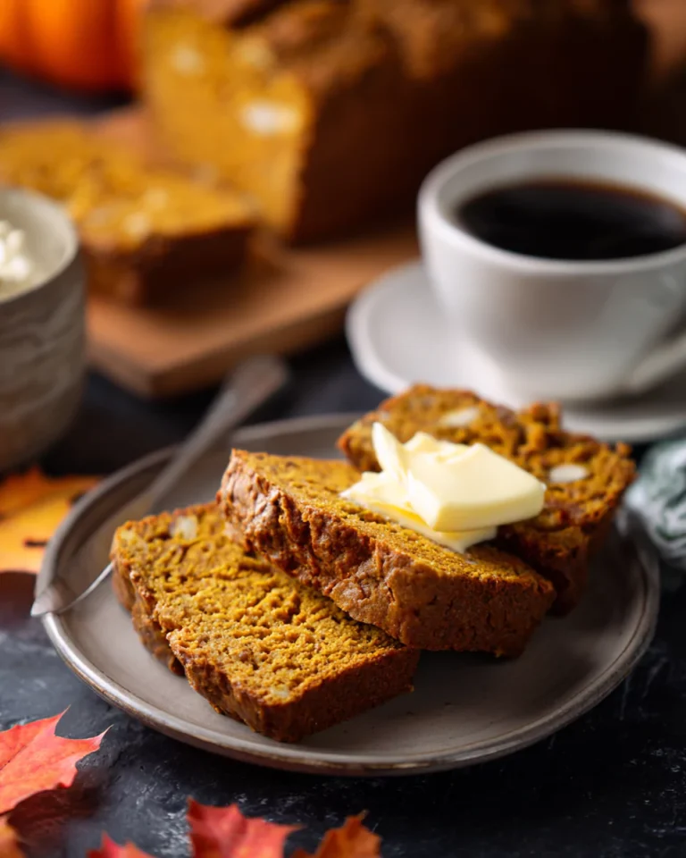 Sliced pumpkin bread served with coffee